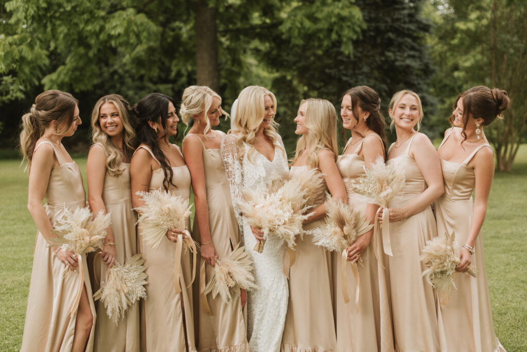 elegant country bride and bridesmaids in neutral colored bridesmaid dresses with a pampas bouquets at an Annapolis, Maryland family farm wedding