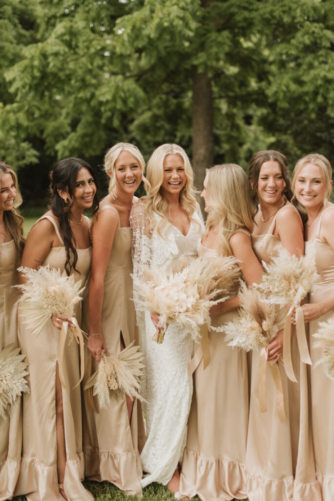 elegant country bride and bridesmaids in neutral colored bridesmaid dresses with a pampas bouquets at an Annapolis, Maryland family farm wedding