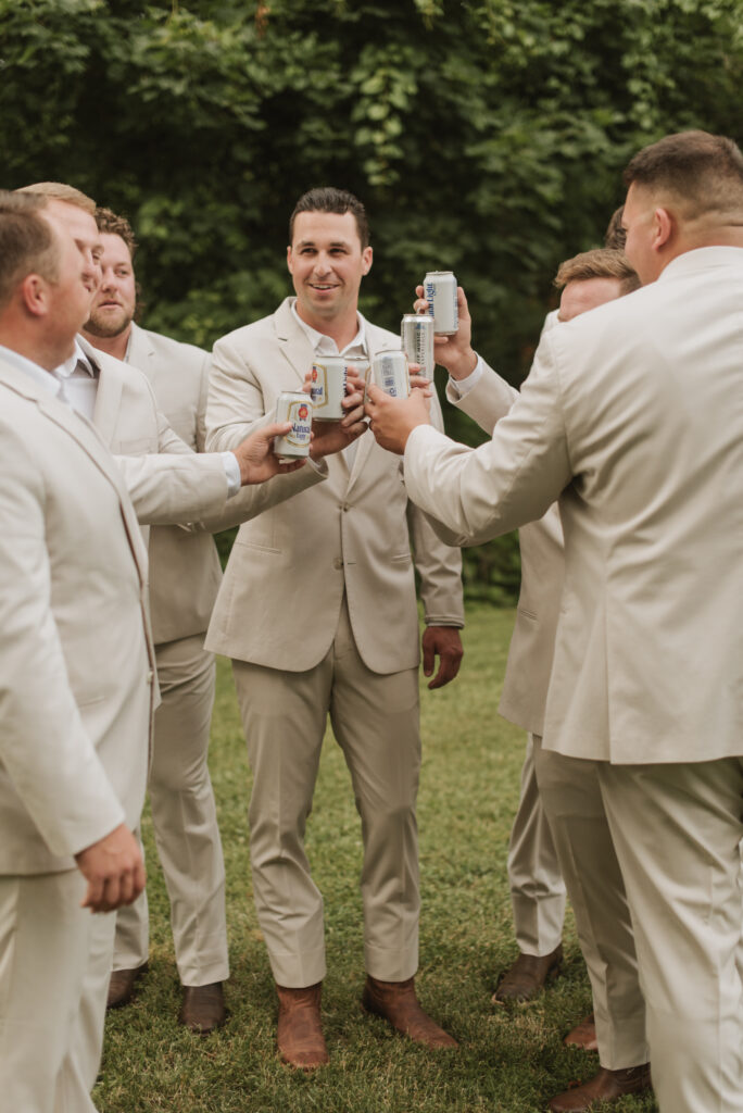 cream beige groom and groomsman outfits with beers