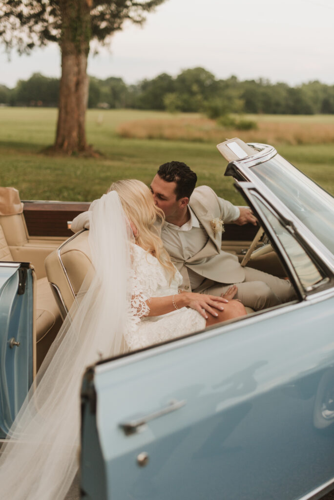 elegant country bride with a blue vintage car at an Annapolis, Maryland family farm wedding