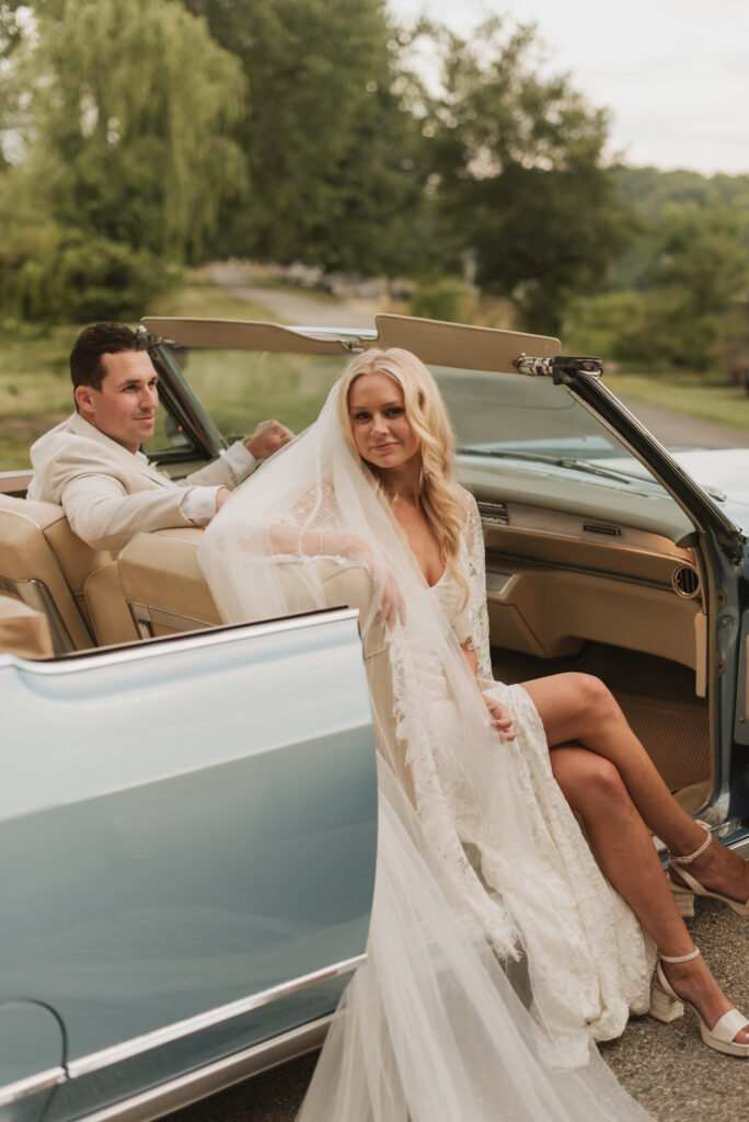 elegant country bride with a blue vintage car at an Annapolis, Maryland family farm wedding