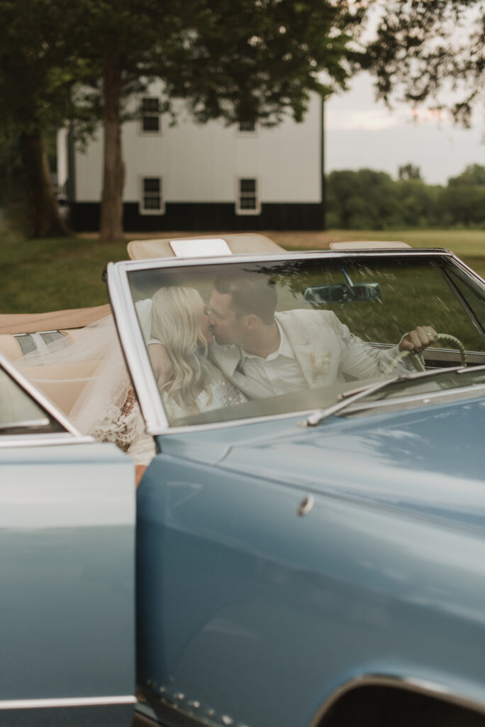 elegant country bride with a blue vintage car at an Annapolis, Maryland family farm wedding