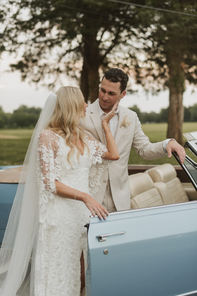 elegant country bride with a blue vintage car at an Annapolis, Maryland family farm wedding