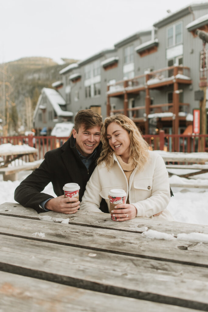 snowy colorado mountain winter engagement photos at keystone with starbucks coffee