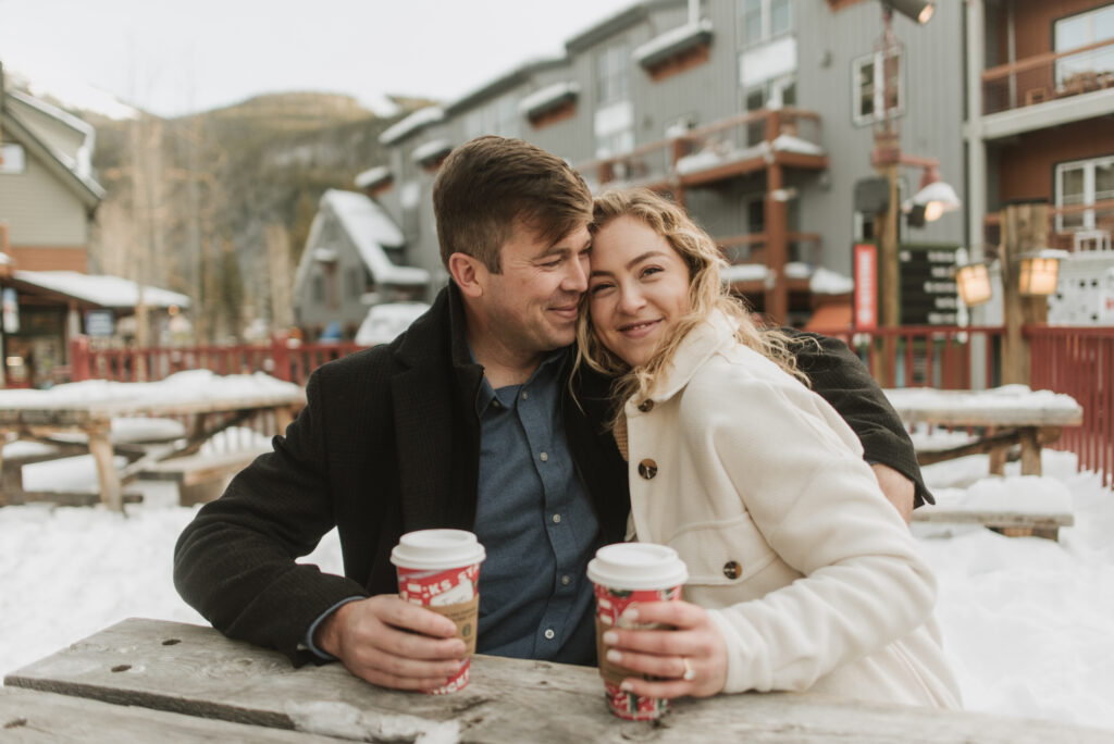 snowy colorado mountain winter engagement photos at keystone with starbucks coffee